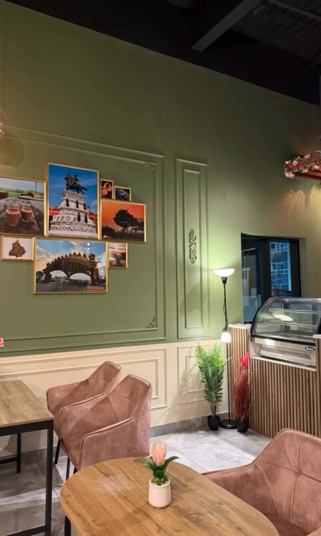 Interior dining area at Chai on 34 with framed Punjab artwork and dessert display, Edmonton
