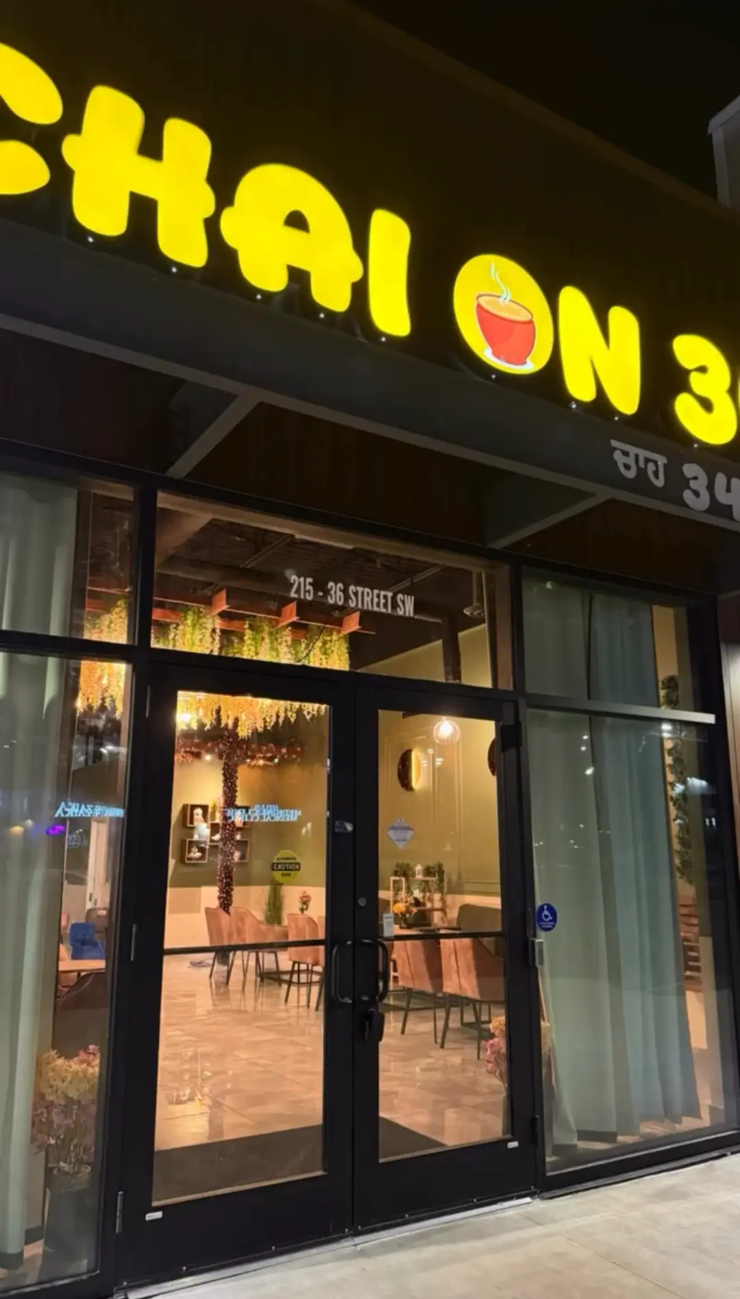 Chai on 34 storefront lit up at night in Charlesworth, Edmonton